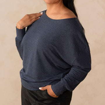 woman wearing a navy long sleeve sweatshirt